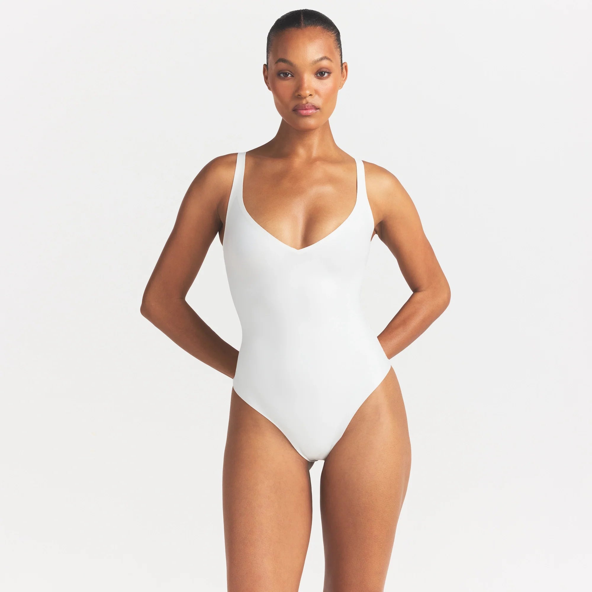 SKIMS BODY UNLINED PLUNGE THONG BODYSUIT | IVORY